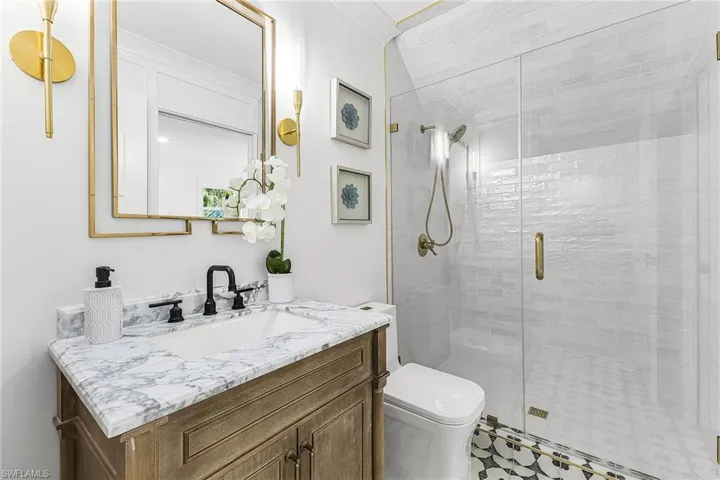 Full bath with vanity and a stall shower