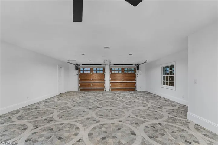 Unfurnished living room featuring baseboards and recessed lighting