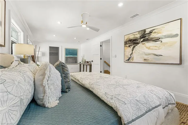 Bedroom featuring a spacious closet, ornamental molding, ceiling fan, and recessed lighting
