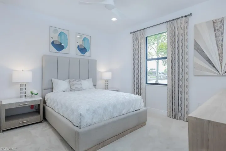 Bedroom featuring ceiling fan and light carpet
