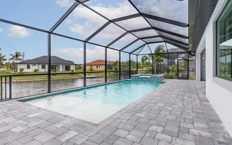 View of pool featuring an in ground hot tub, a patio, and a lanai