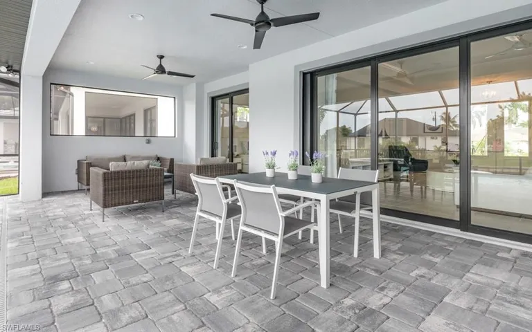 Tiled dining space with ceiling fan and a healthy amount of sunlight