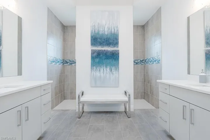 Bathroom featuring tile patterned floors, separate shower and tub, and vanity