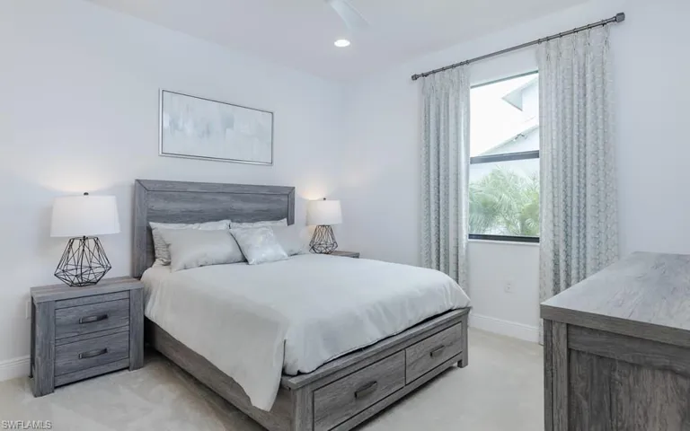 Carpeted bedroom featuring ceiling fan