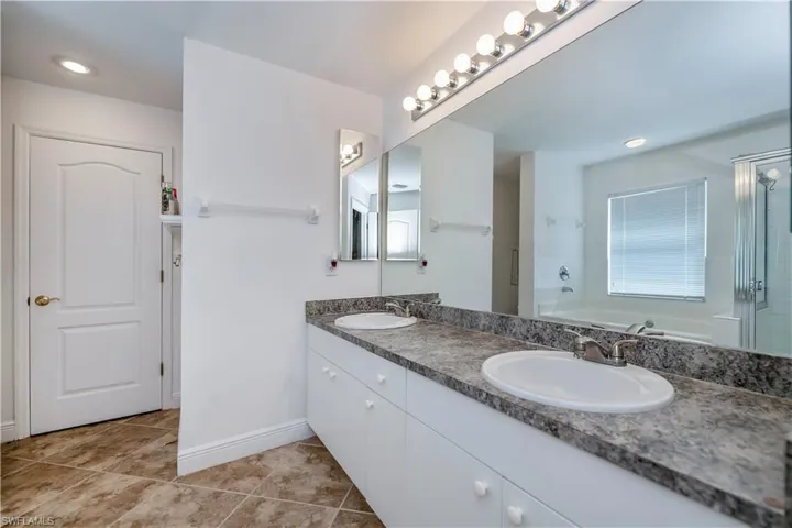 Bathroom featuring vanity, tile patterned floors, and independent shower and bath