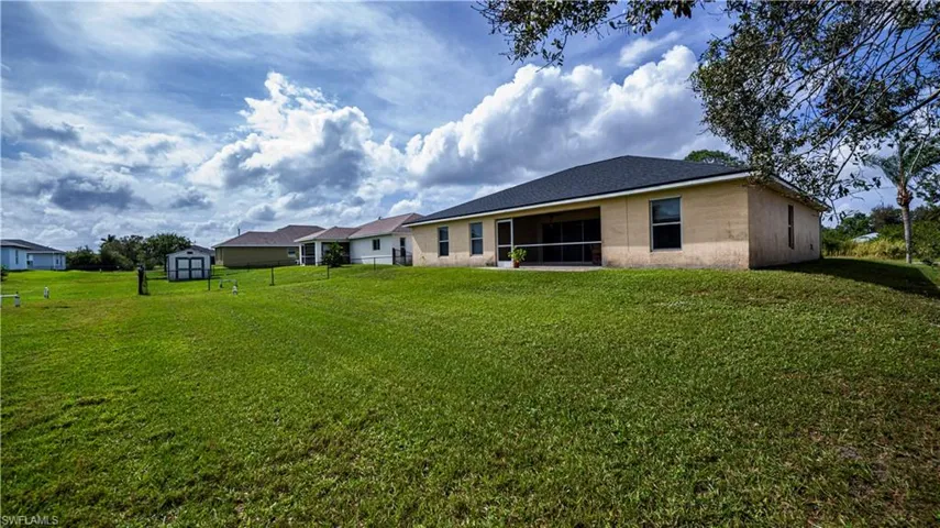 Rear view of house with a yard