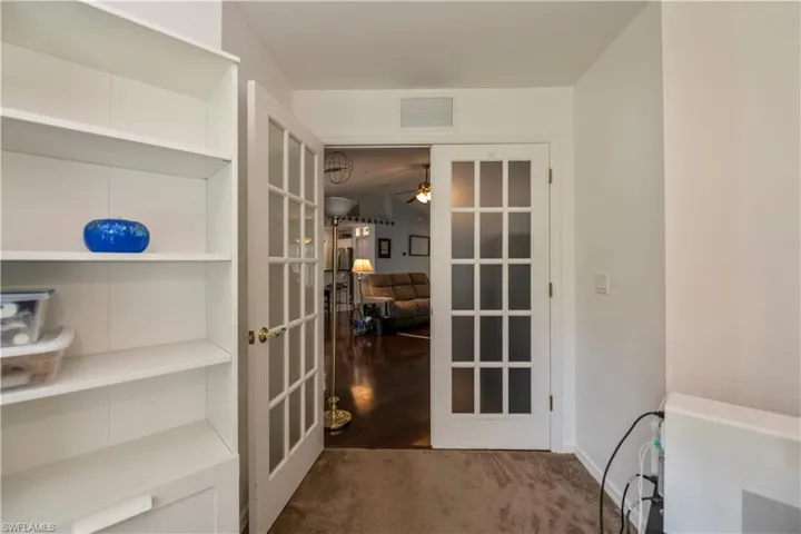 Doorway to outside featuring hardwood / wood-style flooring, ceiling fan, and french doors