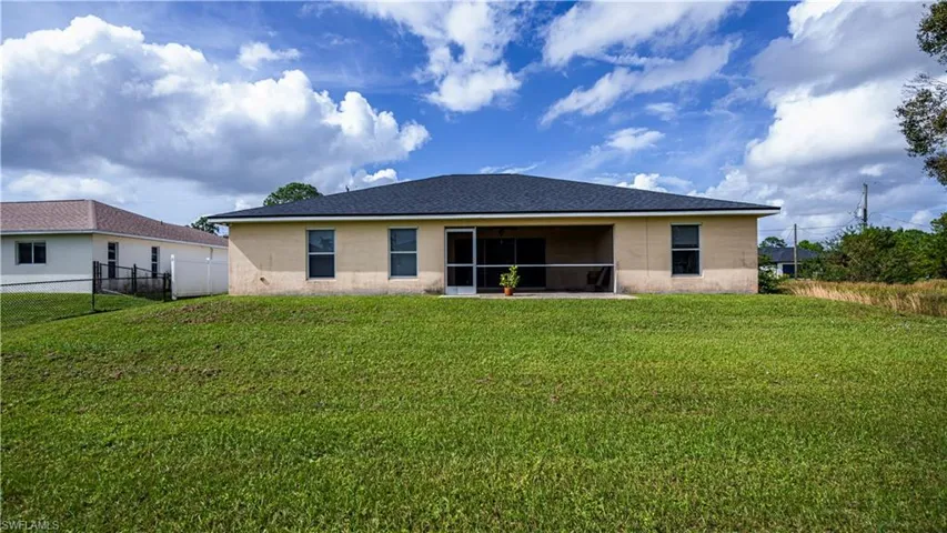 Rear view of house with a yard