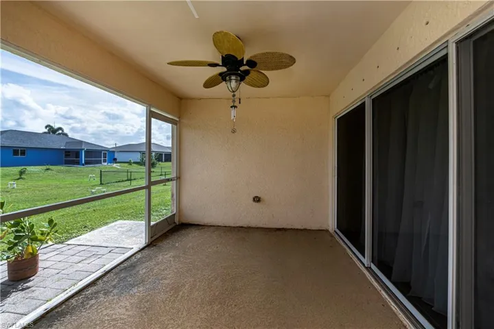 Unfurnished sunroom with ceiling fan