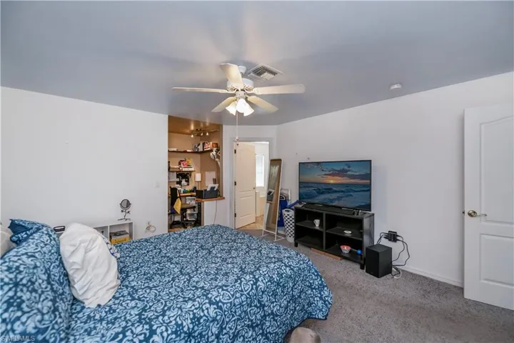 Bedroom with ceiling fan and carpet flooring