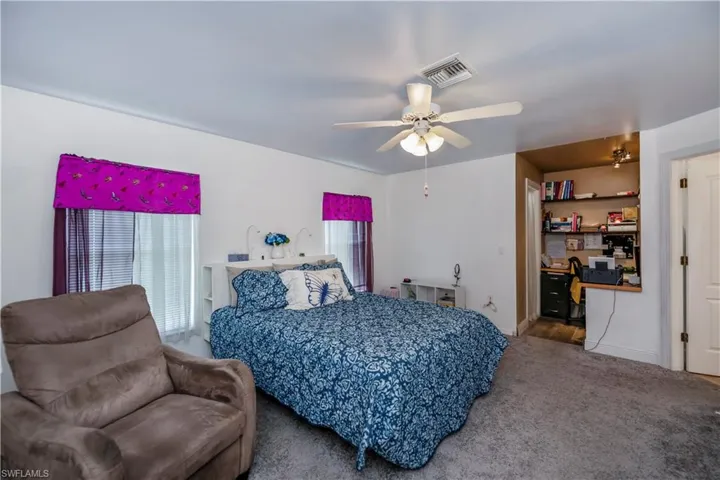Bedroom featuring ceiling fan and carpet