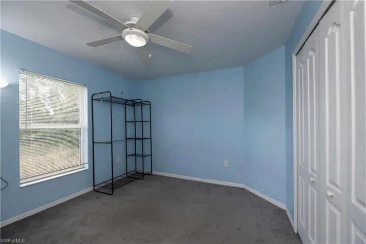 Unfurnished bedroom featuring a closet, ceiling fan, and carpet floors