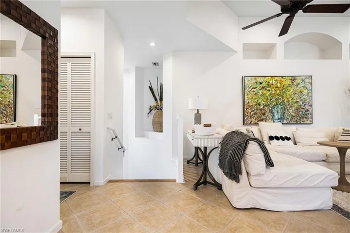 Bedroom featuring light tile patterned flooring, ceiling fan, and a closet