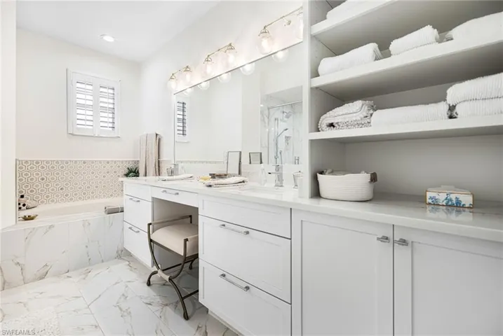 Bathroom with vanity and separate shower and tub