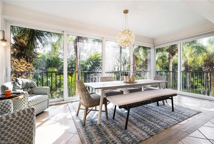 Sunroom featuring an inviting chandelier