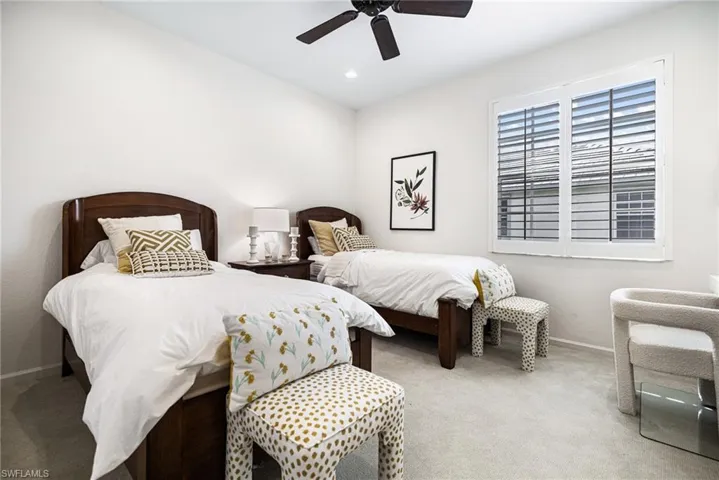Carpeted bedroom with ceiling fan