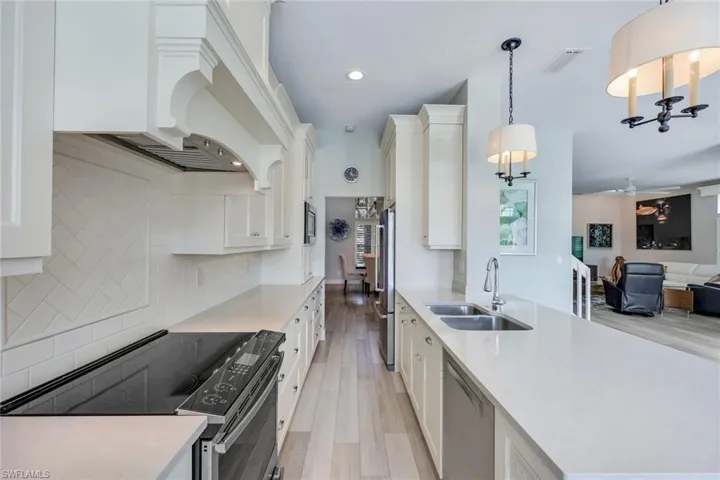Kitchen features shaker cabinets, quartz countertops and stainless appliances.