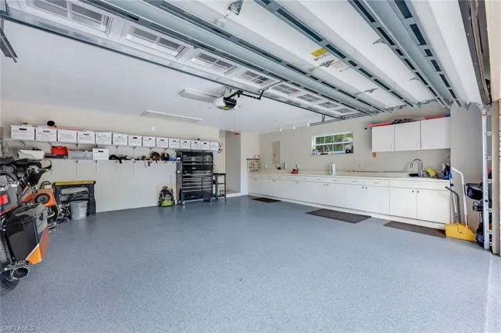 Garage offers PLENTY of room for two cars AND a golf cart!
