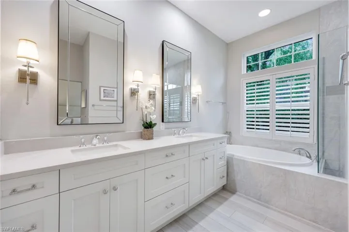 First floor primary bathroom features dual sinks, soaking tub and a walk-in shower.