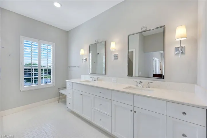 Second floor ensuite primary bathroom features dual sinks and a walk-in shower.