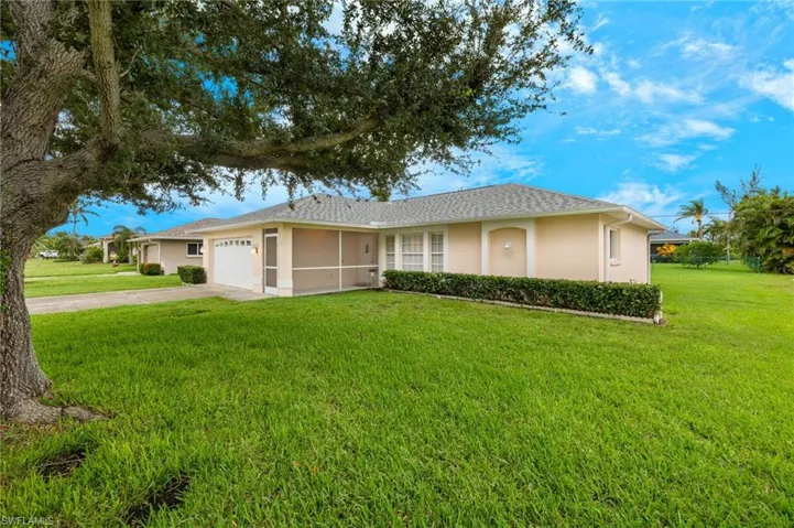 Ranch-style house featuring a garage and a front yard