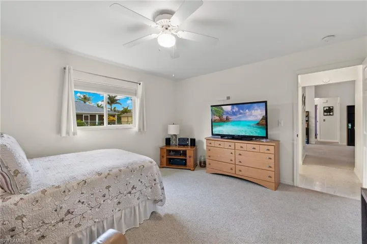 Master Bedroom Carpeted bedroom with ceiling fan