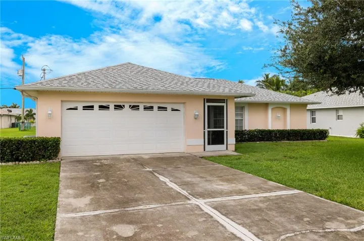 Ranch-style home with a garage and a front yard