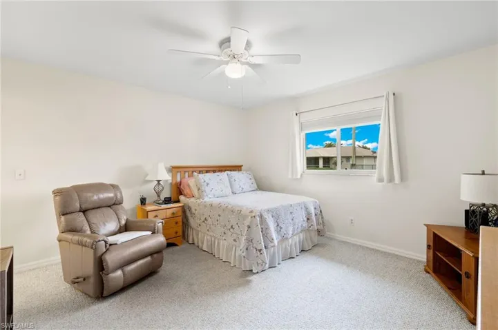 Master Bedroom with light colored carpet and ceiling fan