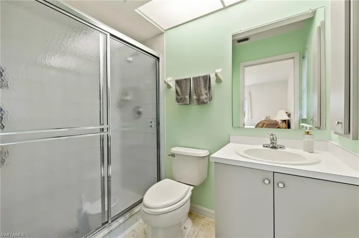 Master Bathroom featuring vanity, toilet, tile patterned floors, and an enclosed shower