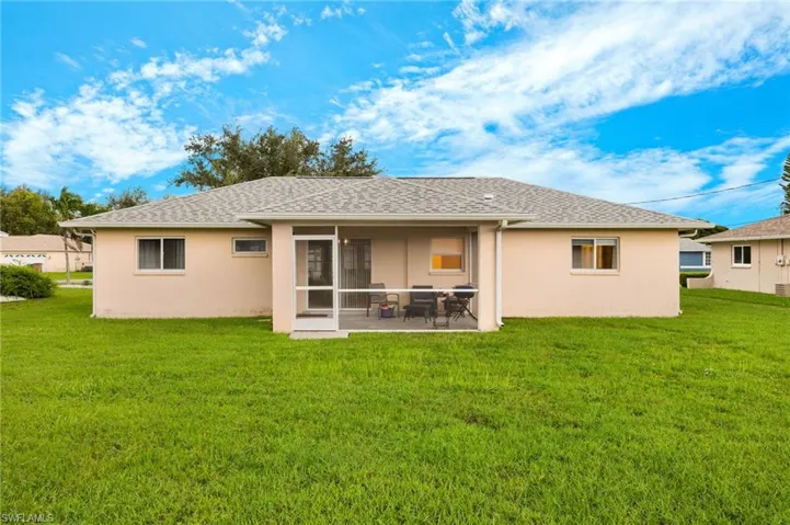 Back of house featuring a yard and a patio area