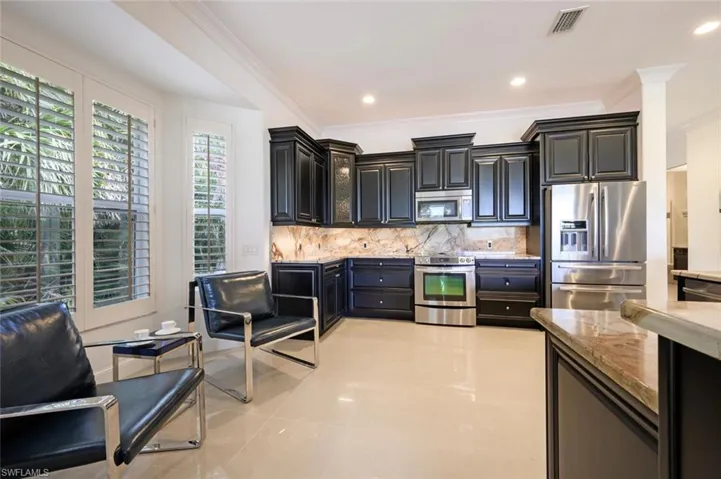 Custom Cabinets, Granite Counter Tops with Granite Backsplash and Stainless Steel Appliances