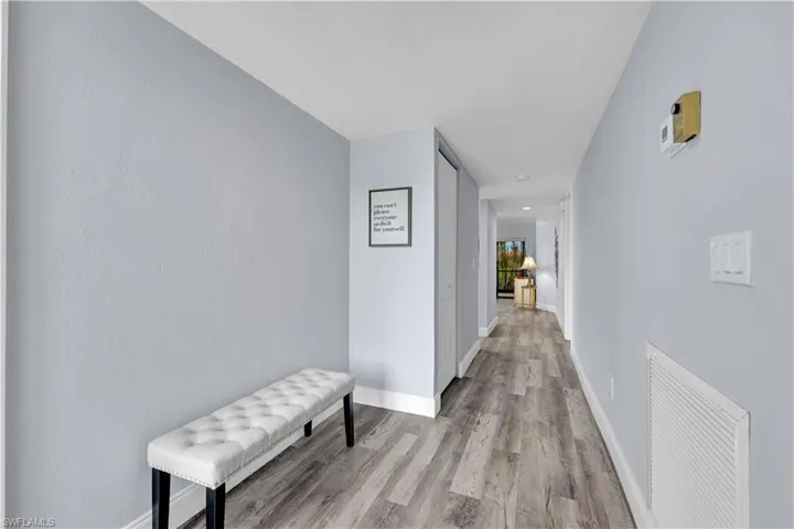Hallway with light wood finished floors and baseboards