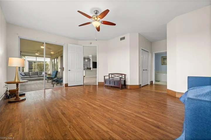 Living area with wood finished floors and ceiling fan