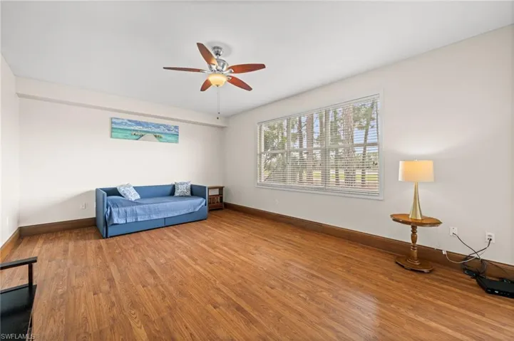 Living area featuring wood finished floors and a ceiling fan