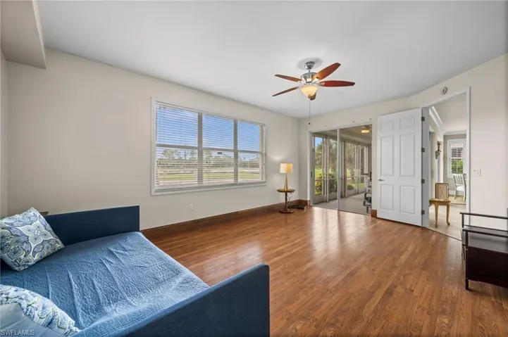 Living area with wood finished floors and a ceiling fan