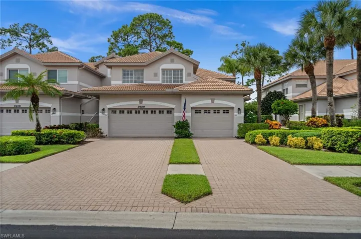 Mediterranean / spanish house featuring a garage, stucco siding, decorative driveway, and a tiled roof