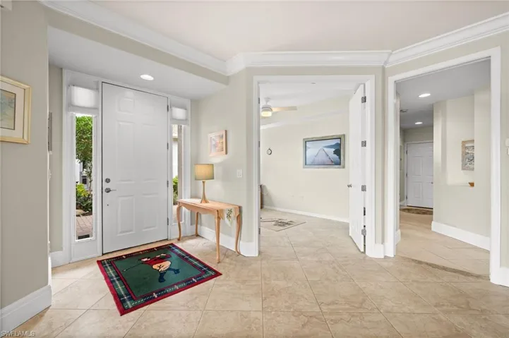 Entryway featuring crown molding, recessed lighting, light tile patterned floors, and ceiling fan
