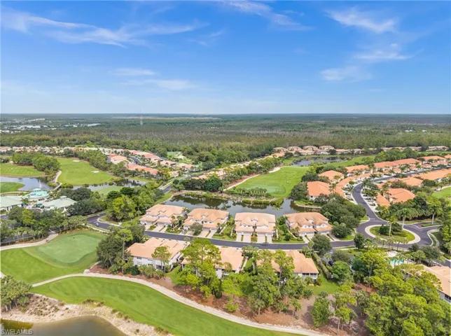 Aerial overview of property's location with nearby suburban area, a local golf course, and a large body of water