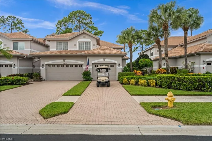 Mediterranean / spanish-style home featuring decorative driveway, a tile roof, stucco siding, and a front lawn