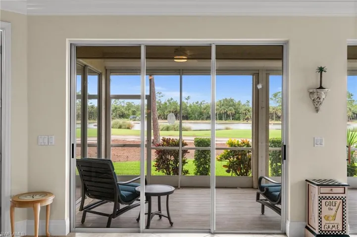 Doorway featuring ornamental molding, a water view, and wood finished floors