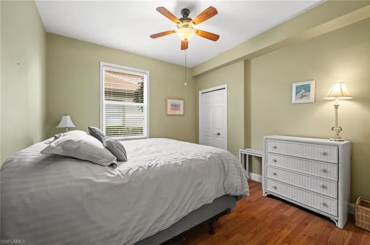 Bedroom with wood finished floors, a ceiling fan, and a closet