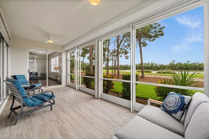 Sunroom / solarium with ceiling fan, wood finished floors, and view of golf course