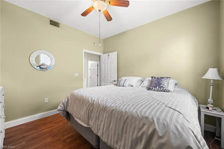 Bedroom featuring dark wood-style flooring and ceiling fan