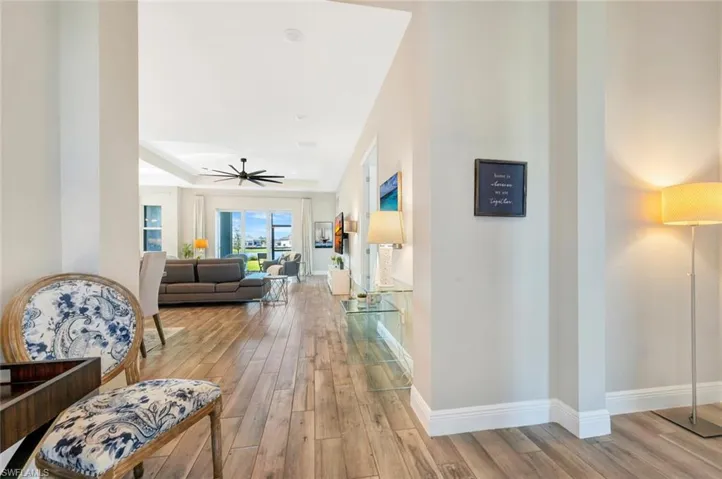 Foyer featuring light hardwood / wood-style flooring and a tray ceiling