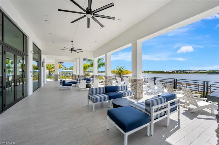 View of terrace featuring a water view, an outdoor hangout area, and ceiling fan