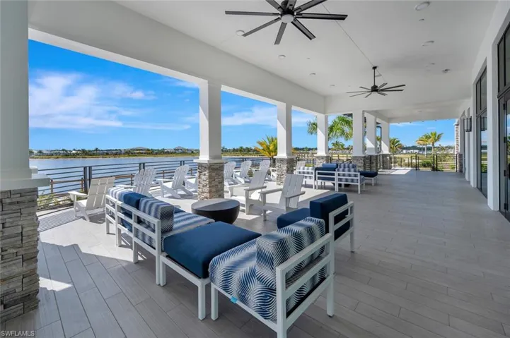 Wooden deck featuring ceiling fan, outdoor lounge area, and a water view