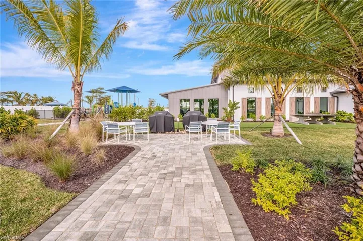 View of property's community with a patio area and a lawn