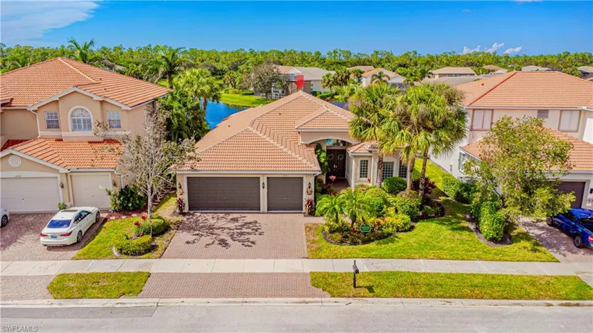 View of front of home featuring a water view, a garage, and a front yard