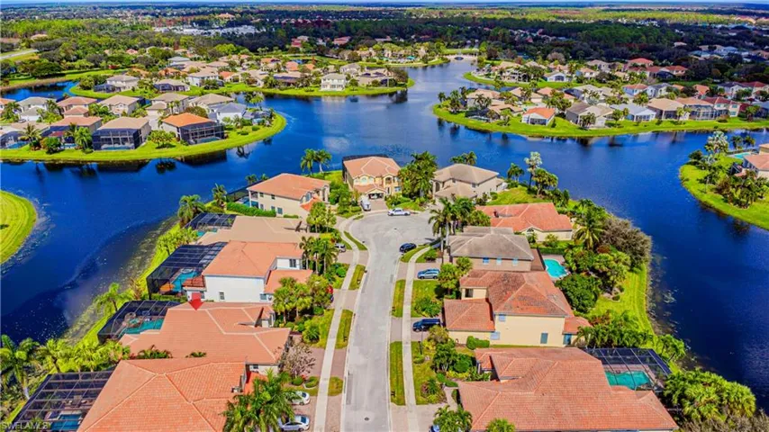 Birds eye view of property with a water view