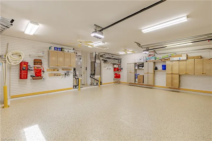 Garage with ceiling fan and a garage door opener